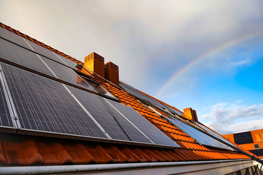 Services a-solar-panel-on-a-roof-with-a-rainbow-in-the-background-0syvpkyzc-m